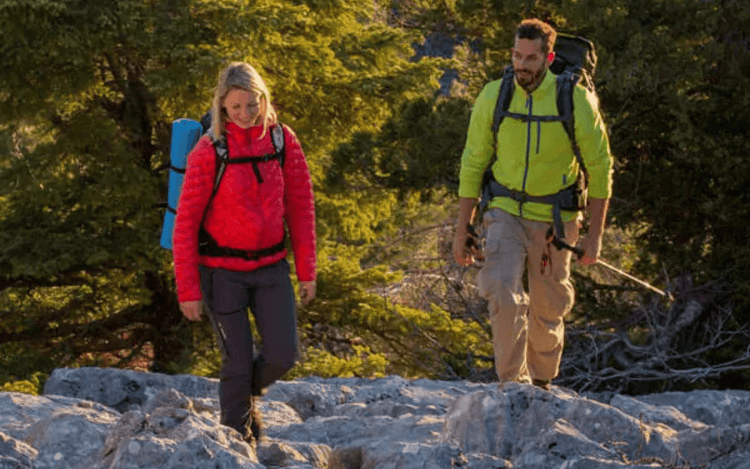 Outdoor adventurers wearing high-performance jackets and gear while hiking on rocky terrain in nature - Outdoor Apparel - Adventure Gear From Global Trekker.